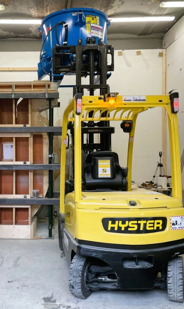 Hyster forklift lifting up a cement barrel